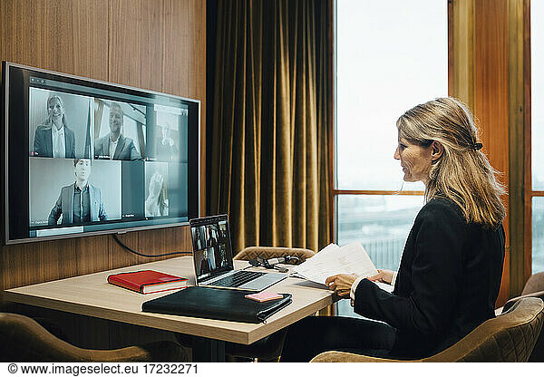 Female lawyer in video conference with colleagues in office during pandemic