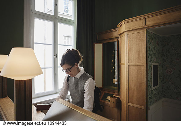Female lawyer standing at desk in library