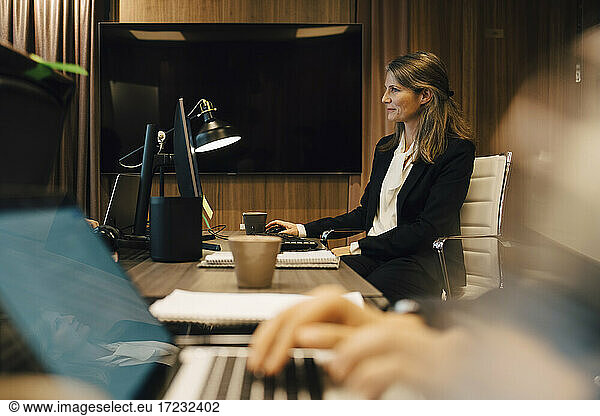 Female lawyer working on computer in board room at office