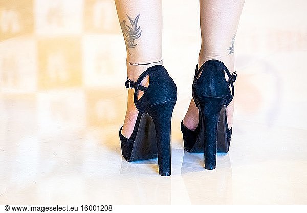 Female legs with haute couture shoes.