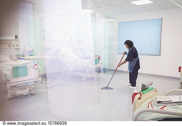 Female orderly mopping hospital ward floor