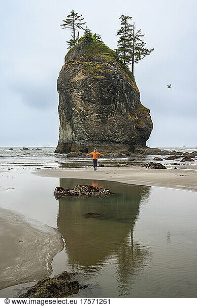 Female posing next to a sea stack on the olympic coast at low tide