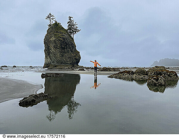 Female posing next to a sea stack on the olympic coast at low tide