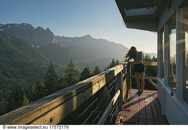 Female posing on the deck of a fire lookout in the Cascade Mountains