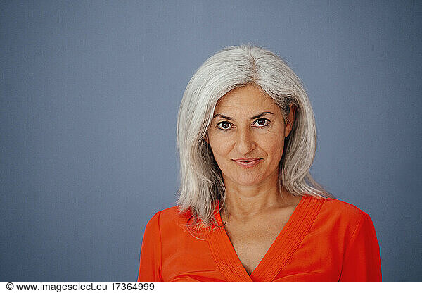 Female professional standing against gray background