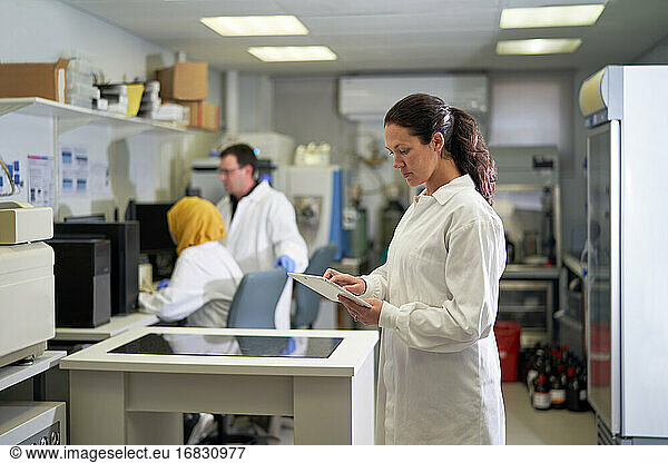Female scientist using digital tablet in laboratory