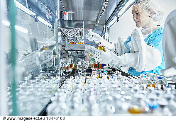 Female scientist working in cleanroom of a microbiological lab