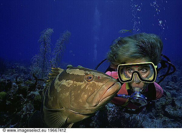 Female scuba diver and grouper  Cayman Brac