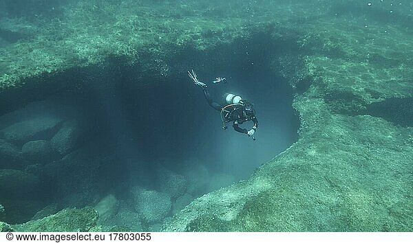 Female scuba diver near the exit from the cave. Cave diving in Mediterranean Sea  Cyprus  Europe