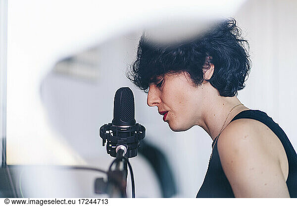 Female singer recording in studio