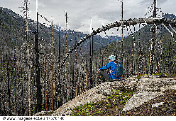 Female sits on ledge in the Entiat river valley