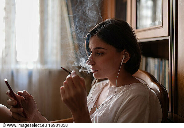 Female smoker browsing mobile phone