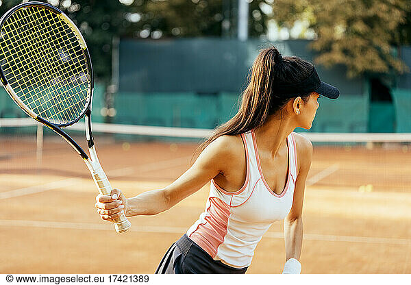 Female sportsperson playing tennis at sports court