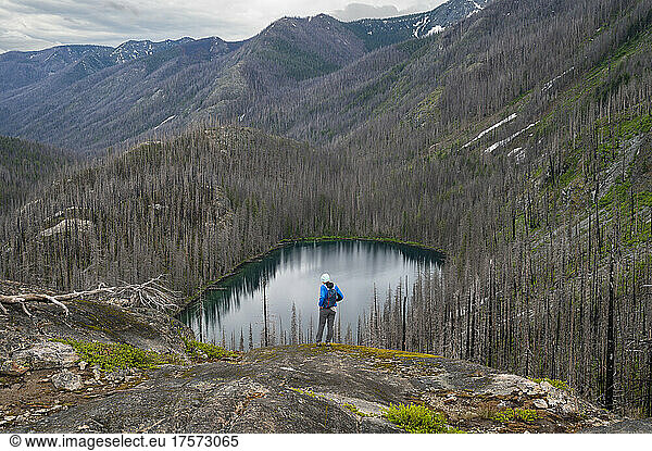 Female stands above an alpine lake in the Entiat river valley