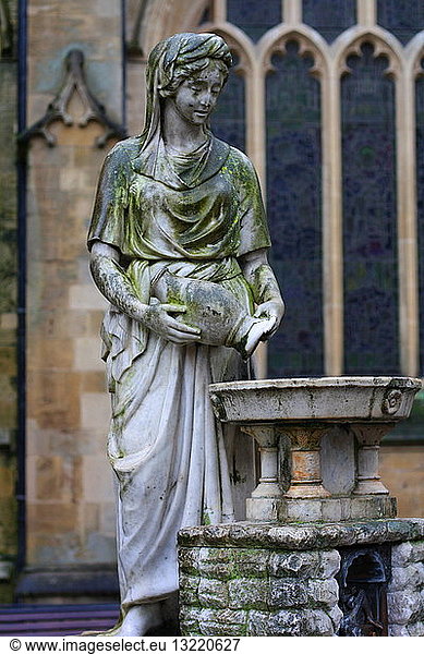 Female statue outside of the Roman baths in Somerset  England. Showing a demure woman emptying a water jug. The base has ''Water is best'' inscribed in English. Statue 1st-4th century AD on a modern base.