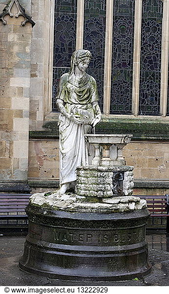 Female statue outside of the Roman baths in Somerset  England. Showing a demure woman emptying a water jug. The base has ''Water is best'' inscribed in English. Statue 1st-4th century AD on a modern base.