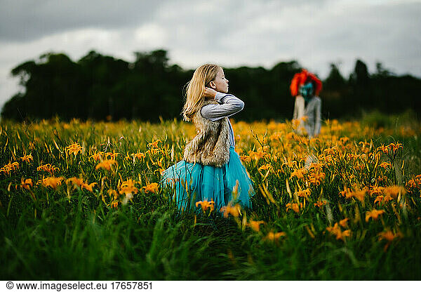 Female strong child is courageous with monster orange flower field