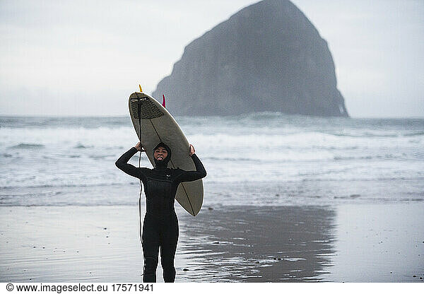 Female surfer having fun after catching waves is Coastal Oregon