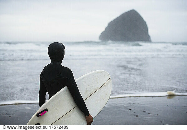 Female surfer looking to catch waves is Coastal Oregon