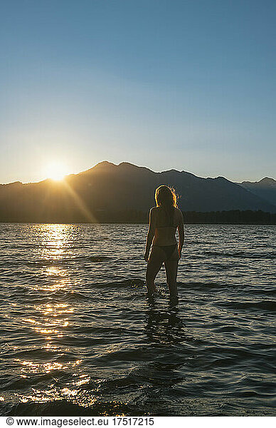 Female swimming in bikini during sunset at lake wenatchee