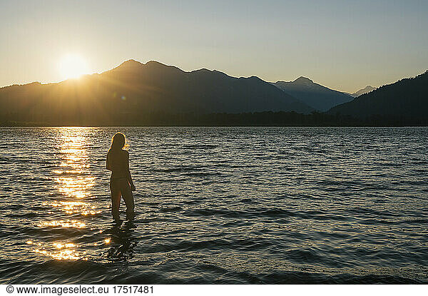 Female swimming in bikini during sunset at lake wenatchee