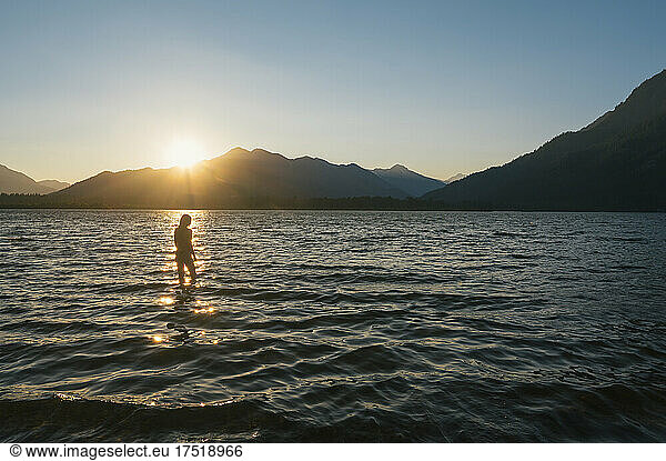 Female swimming in bikini during sunset at lake wenatchee