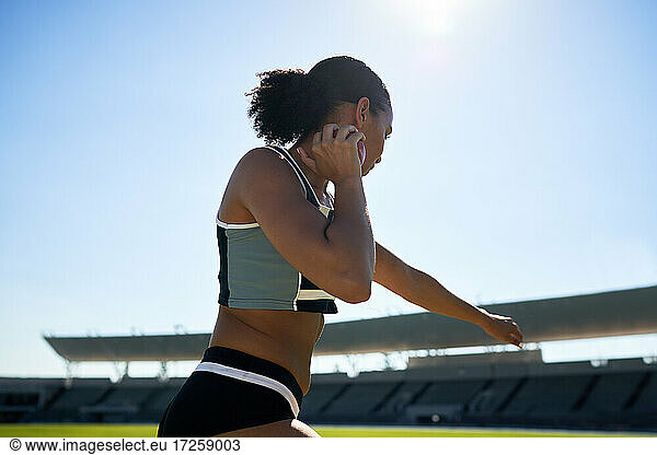 Female track and field athlete throwing shot put