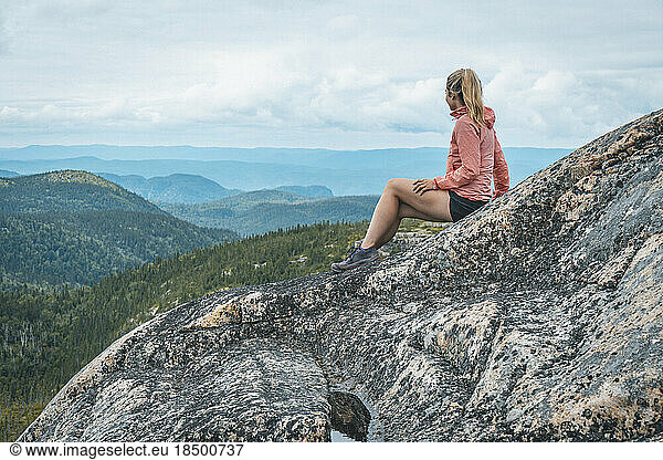 Female Trail Runner Resting on Mountain Ridge in Saguenay