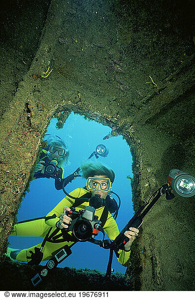 Female underwater photographer on shipwreck  Little Cayman.