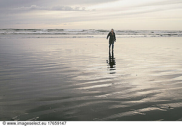 Female walking on the beach on the Oregon coast