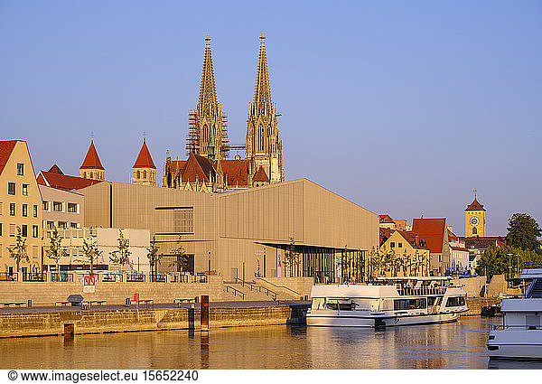 Ferry on Danube river by The Museum of Bavarian History in Regensburg against sky during sunset  Bavaria  Germany