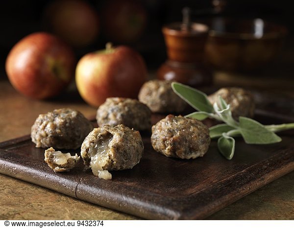 Festive Christmas ingredients of pork  sage and onion stuffing balls with apple sauce centres. Apples and sage