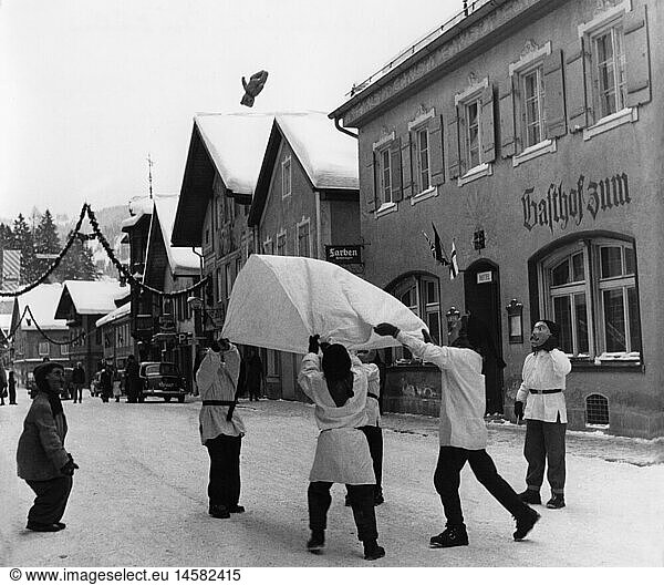 festivities  carnival at Partenkirchen  children with wooden masks throwing teddy bear with blanket in the air  Garmisch - Partenkirchen  1956