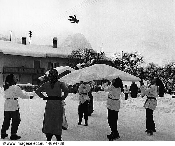 festivities  carnival at Partenkirchen  children with wooden masks throwing teddy bear with blanket in the air  Garmisch - Partenkirchen  1956