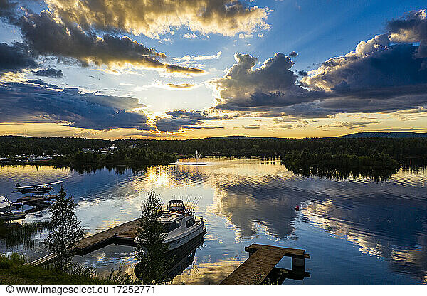 Finland  Lapland  Inari  Dramatic sunset over jetties on shore of Lake Inari