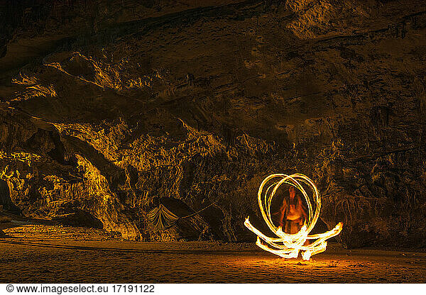 Fire dancer performing on the beach in Railay