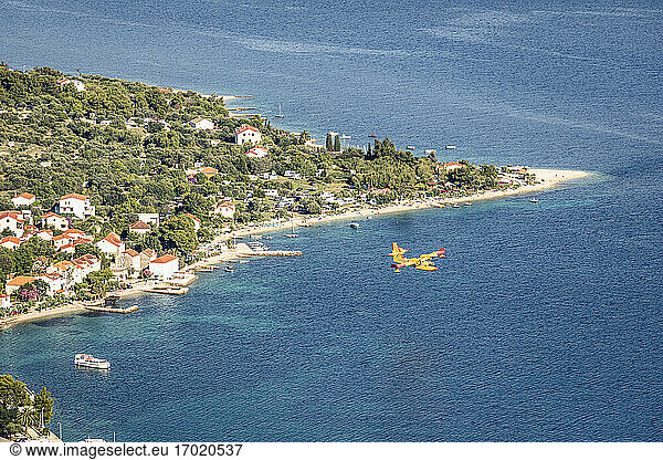 Firefighting airplane flying above coastline