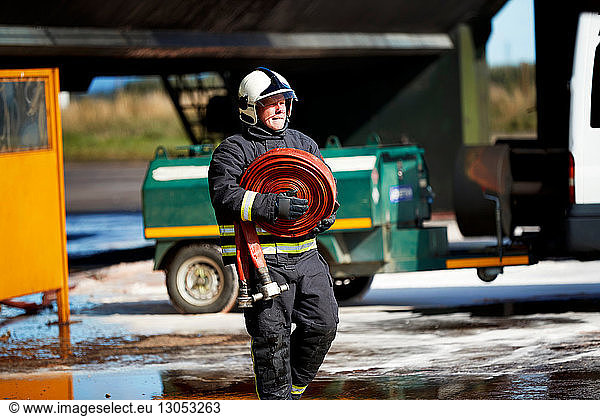 Fireman carrying fire hose reel  Darlington  UK