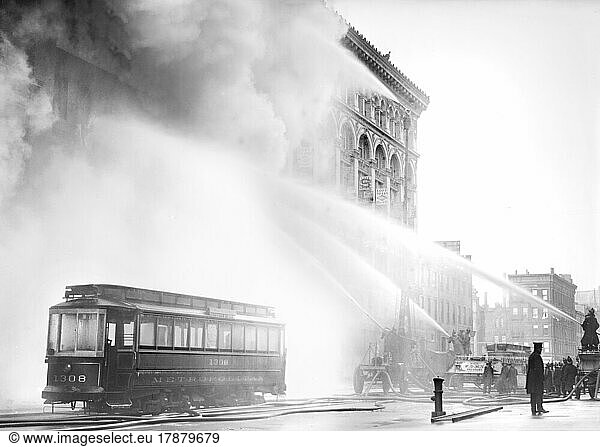 Fireman spraying water on burning building  14th Street  New York City  New York  USA  Bain News Service  December 1909