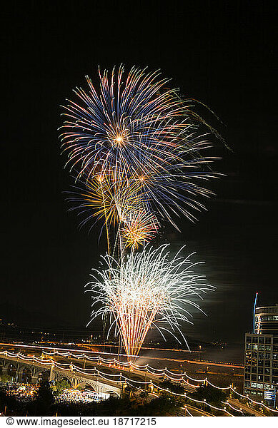 Fireworks over bridge at night