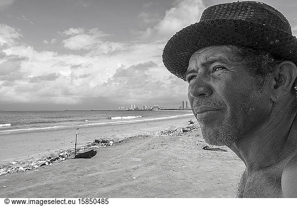 Fisherman from Olinda wearing hat  looking away in the beach