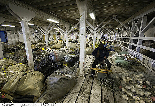 Fisherman hanging fishing nets  South Naknek  Bristol Bay  Alaska  USA