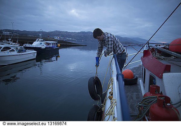 Fisherman preparing trawler  Isle of Skye  Scotland