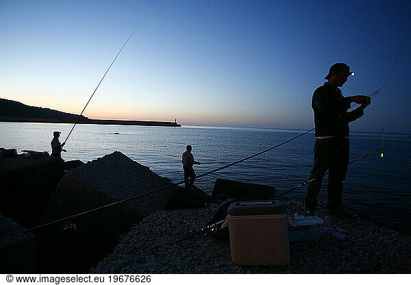 Fishermen at Castellammare del Golfo harbour  Sicily  Italy.