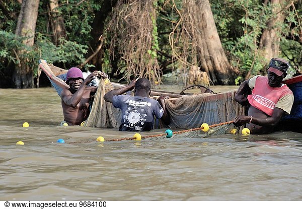 Fishers at work  men hauling big fishing net  Lake Victoria  Kenya.