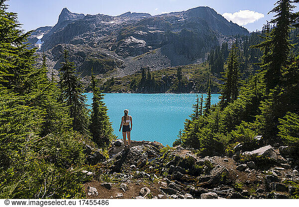 Fit Female Looking At Beautiful Blue Colored Lake