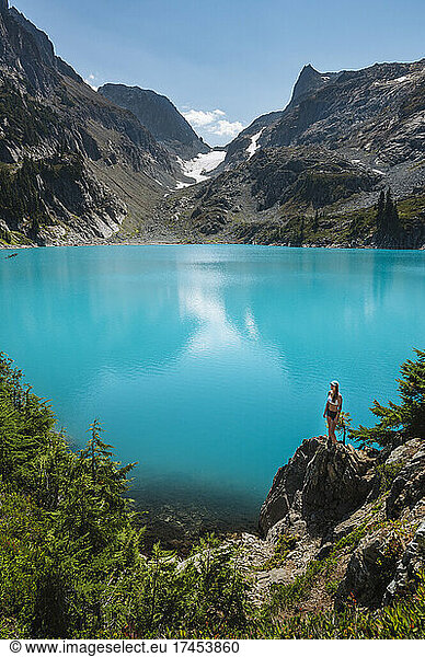 Fit Female Standing Next To Beautiful Turquoise Alpine Lake