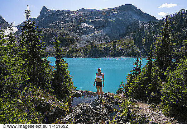 Fit Female With Crop Top In Front of Beautiful Turquoise Lake