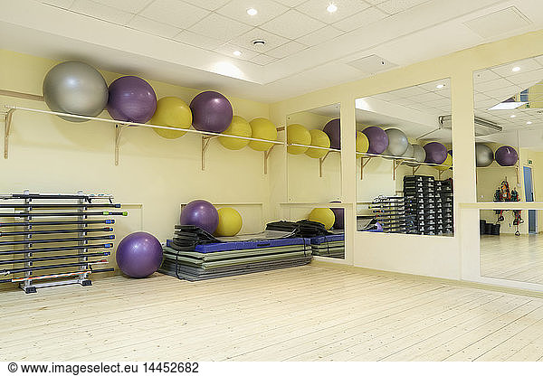 Fitness balls on rack in empty fitness classroom
