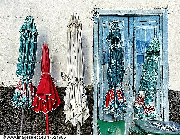Five closed parasols in front of house wall  restaurant  peeling paint  Arrieta  Haria  Lanzarote